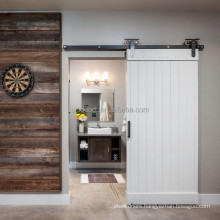 White painted solid wood sliding barn door style for interior bathroom
